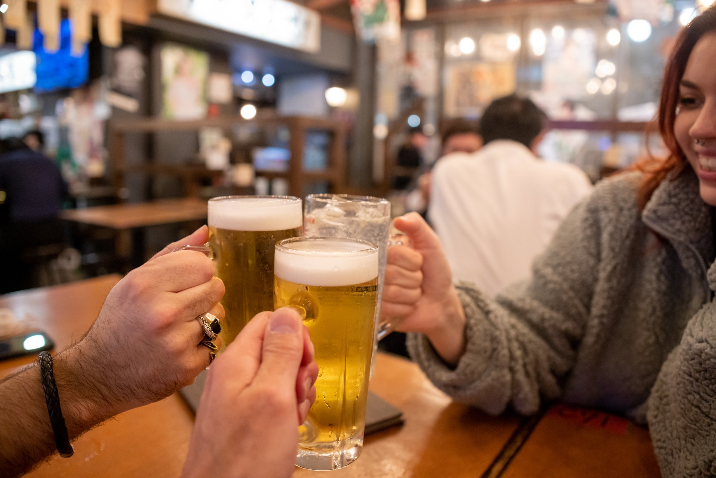 Foreign tourists toasting in Japanese Izakaya bar